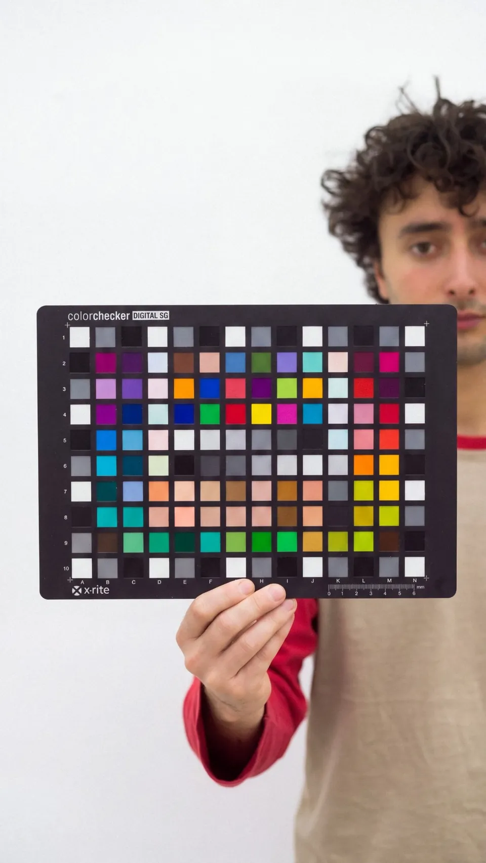 Holding a ColorChecker Digital SG chart